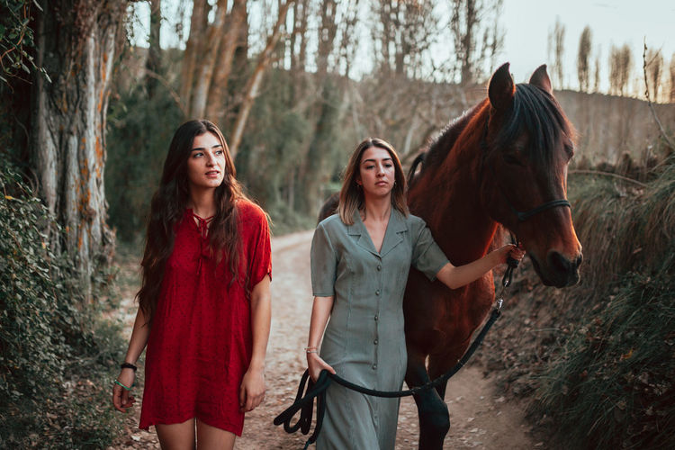 Women with horse in forest
