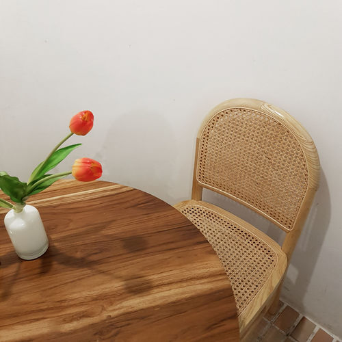 High angle view of tulips in vase on table against wall