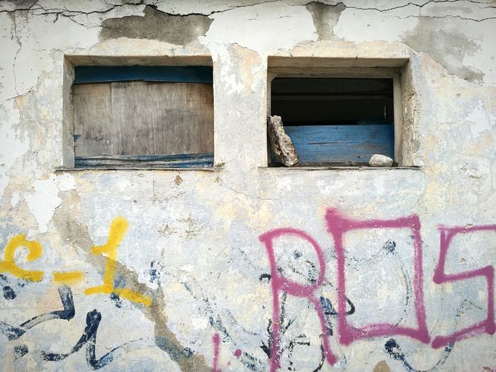 Graffiti on window of abandoned building