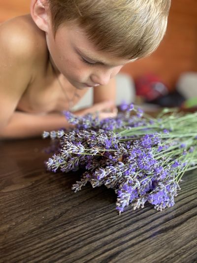 High angle view of child on purple flowering plant
