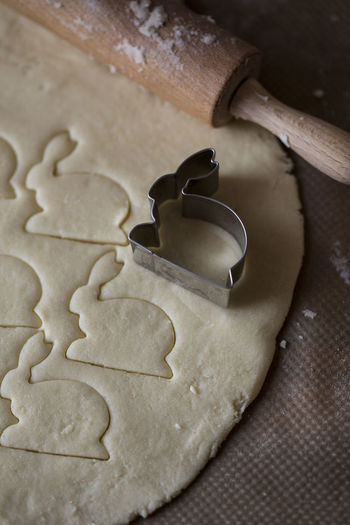 High angle view of cookie cutter on dough in kitchen