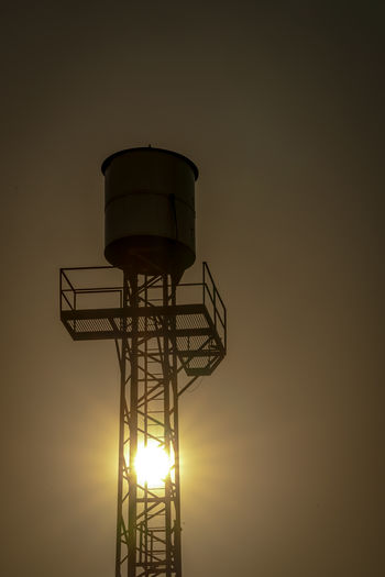 Low angle view of lighthouse against sky during sunset