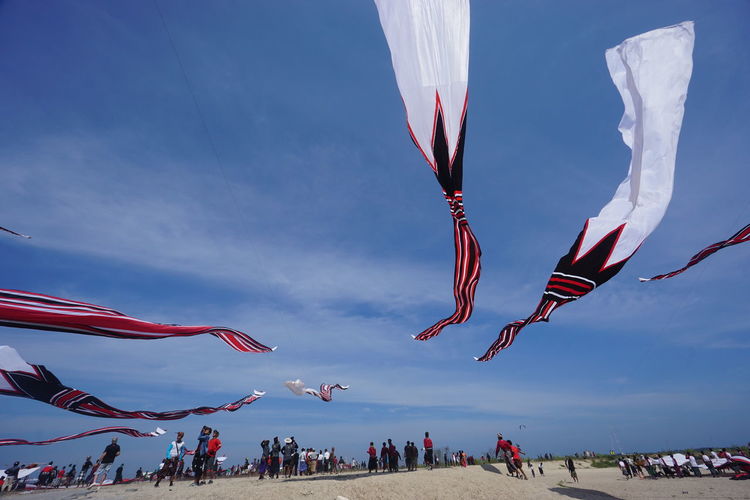 Crowd flying kites at sanur during festival