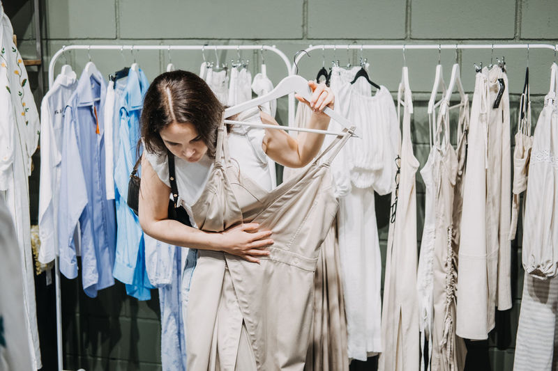 Sustainable fashion, slow fashion, conscious shopping. young latina woman shopping in modern