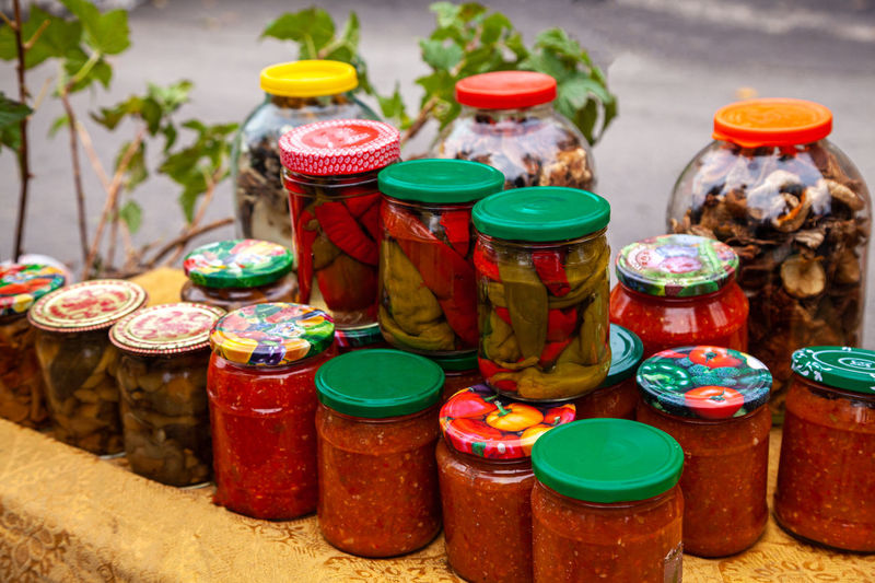 Preserves vegetables in glass jars. jars of pickled vegetables and fruits in the garden pickled food