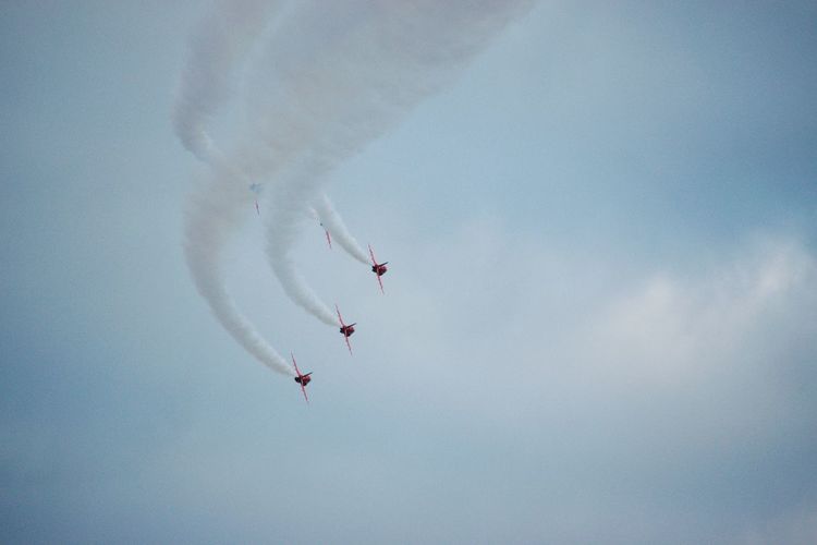 Red arrowsaerobatic display team precision with vapor trails