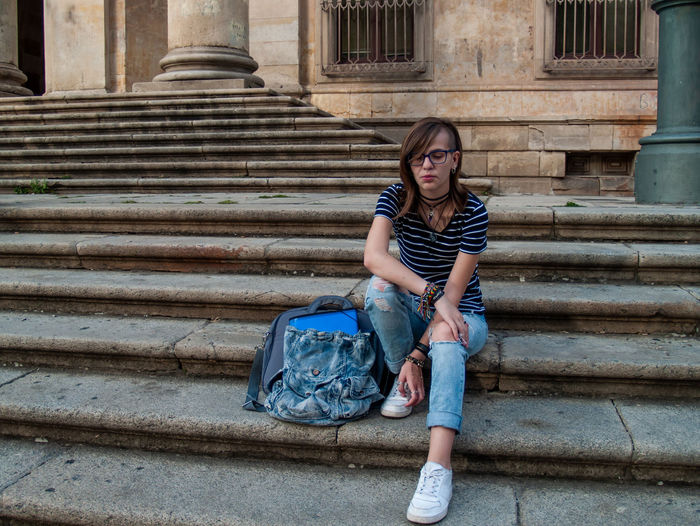 Full length of teenage girl sitting on steps