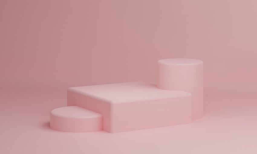 Close-up of pink candle over white background