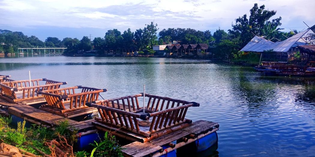 Scenic view of lake by building against sky