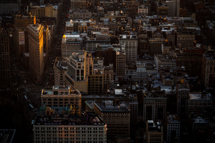 Illuminated flatiron building from the top of the empire state in new york