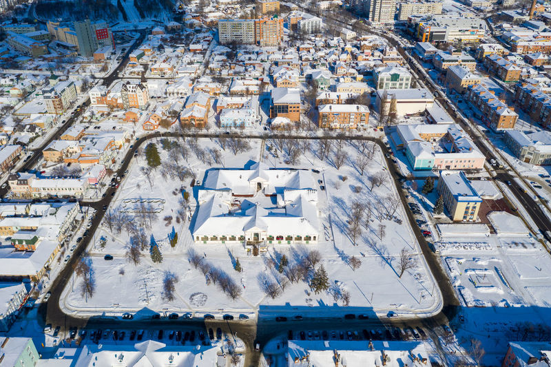Top view of the city. beautiful snowy winter. different buildings, roofs in the snow.