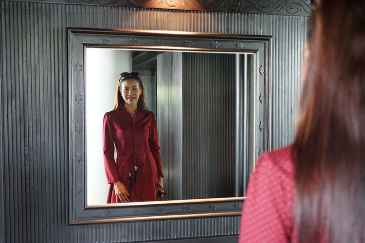 Woman reflecting in mirror