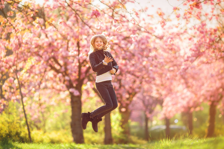 Close-up of woman with pink cherry blossom