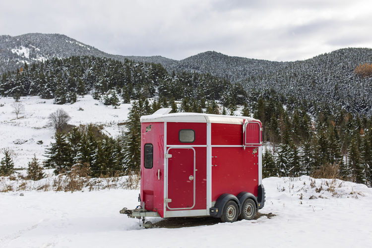 Lifeguard hut on snowy field against mountain