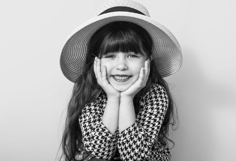 Portrait of a smiling girl against white background
