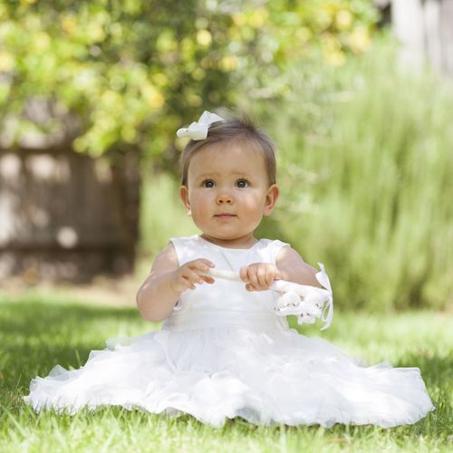 Portrait of cute girl sitting outdoors