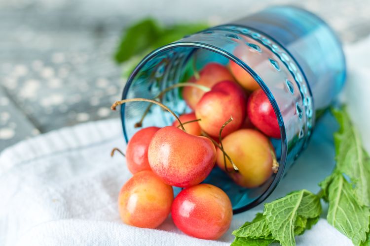 Close-up of cherries in container on table