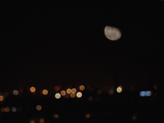 Defocused image of illuminated lights in city at night