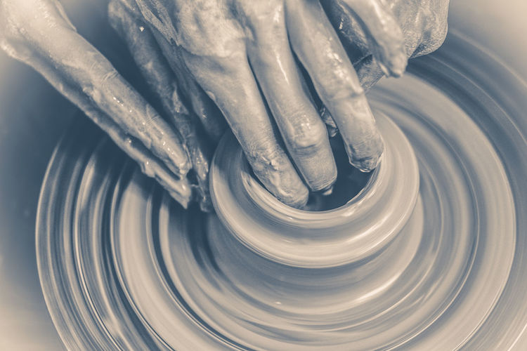 Old vintage photo. the potter molds clay jug pot closeup. monochrome, black and white