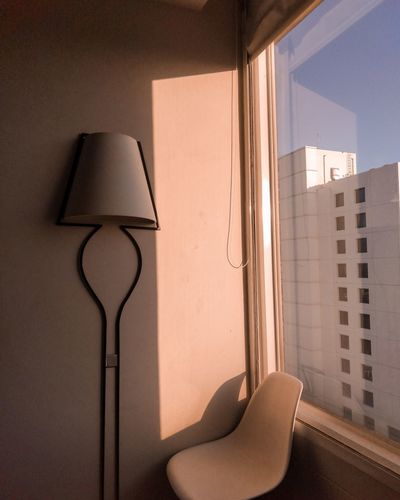 Electric lamp on wall by window at home
