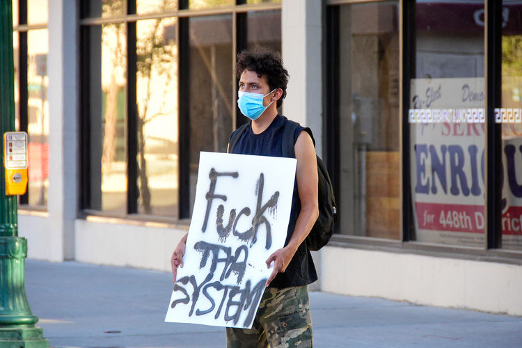 Man standing with protest sign