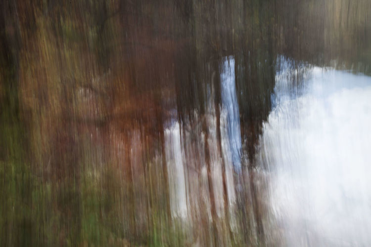 Close-up of water flowing over blurred background