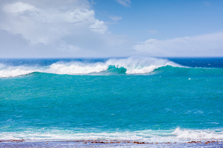 Scenic view of sea wave against sky