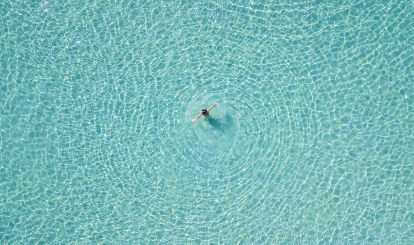 High angle view of woman swimming in sea