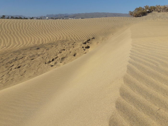 Sand dunes in maspalomas against sky