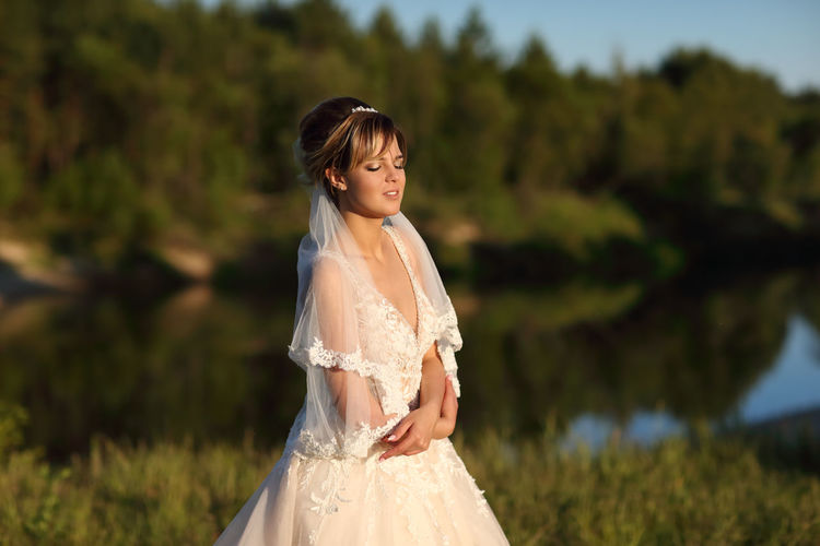 Bride against the background of the river
