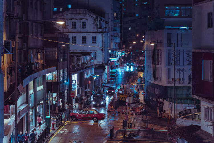 Street amidst buildings in city at night