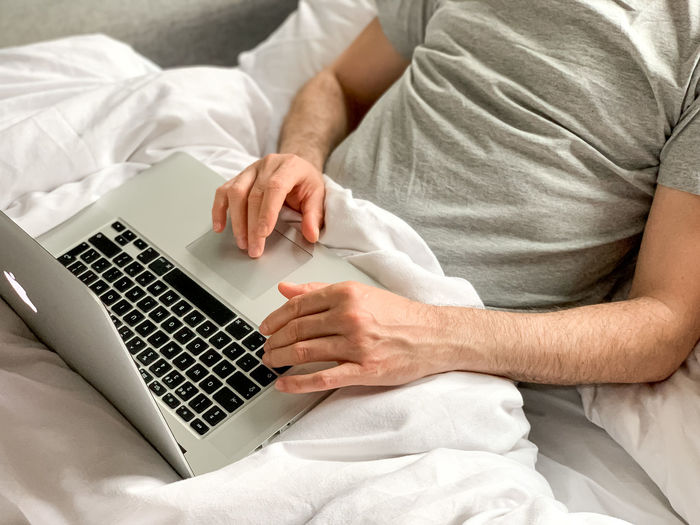 Midsection of man using laptop