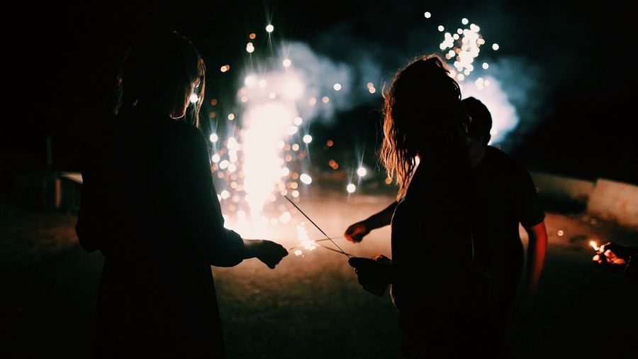 Silhouette people celebrating diwali at night
