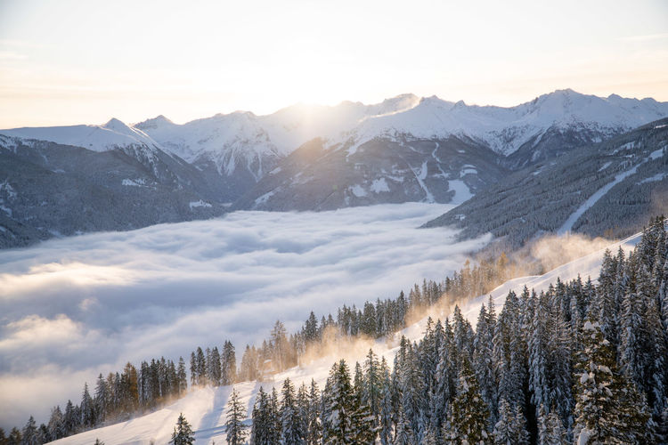 Panoramic view of winter wonderland above a sea of clouds in the gastein valley, austria