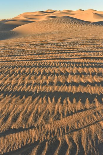 Scenic view of desert against sky during sunset