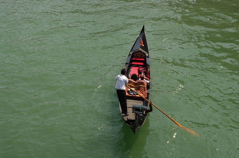 High angle view of people on boat sailing in canal