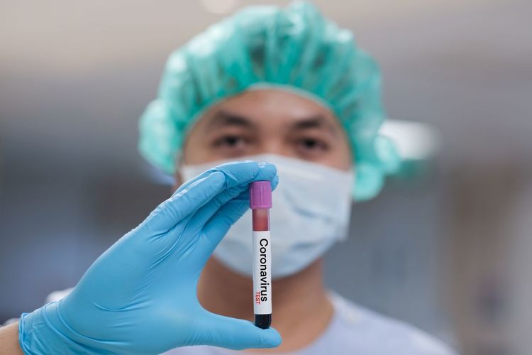 Close-up portrait of doctor holding test tube