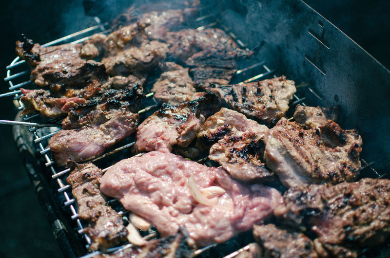 High angle view of meat on barbecue grill