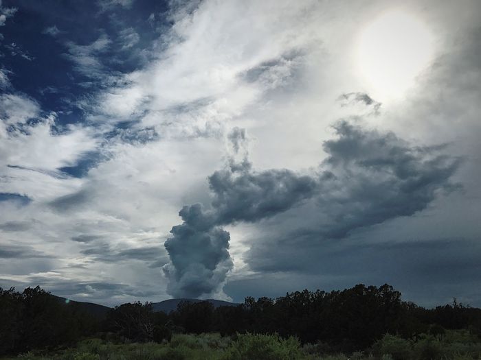 Low angle view of storm clouds over landscape