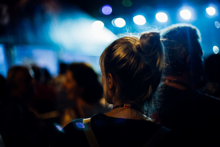 Rear view of people enjoying at music concert