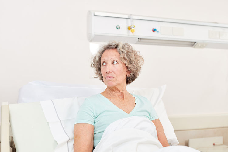 Senior patient resting on bed at hospital