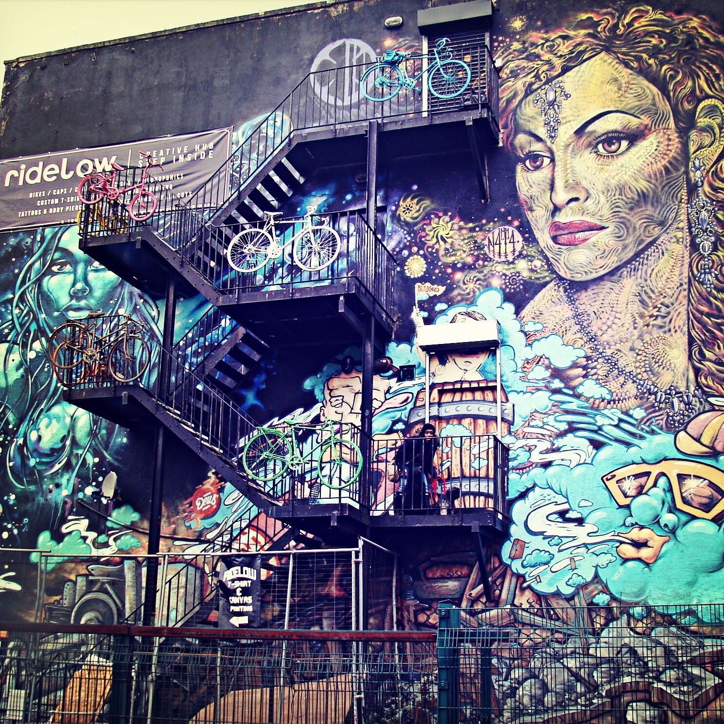 architecture, built structure, building exterior, art, art and craft, graffiti, creativity, low angle view, wall - building feature, building, design, human representation, mural, pattern, day, railing, multi colored, outdoors, steps