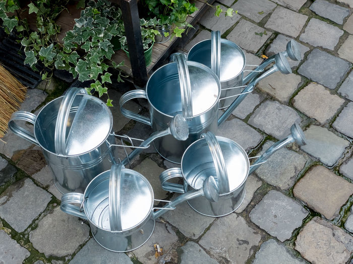 Arrangement of galvanized garden watering cans on a street in brussels belgium europe