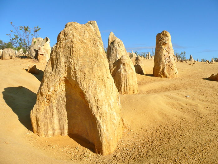Panoramic view of rocks on arid landscape against clear sky