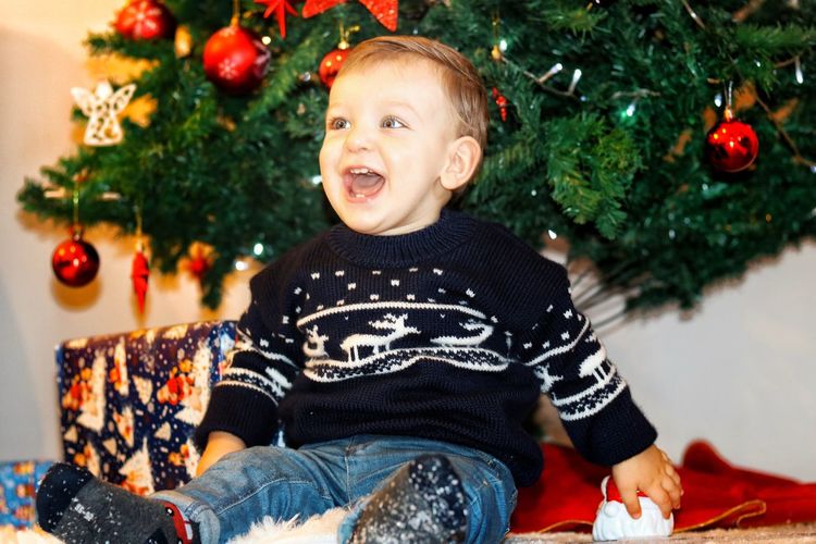 Full length of boy against christmas tree