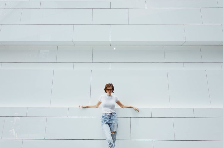 Adult Adults Only Beautiful Woman Casual Clothing Day Front View Happiness Human Body Part Human Hand Indoors One Person One Woman Only People Real People Smiling Standing White Color Women Young Adult Young Women