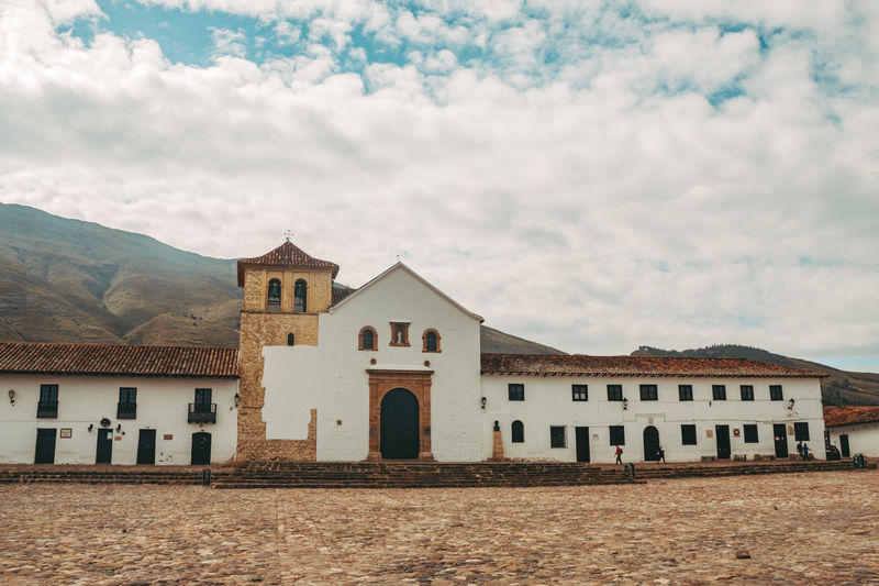 Exterior of houses by buildings against sky