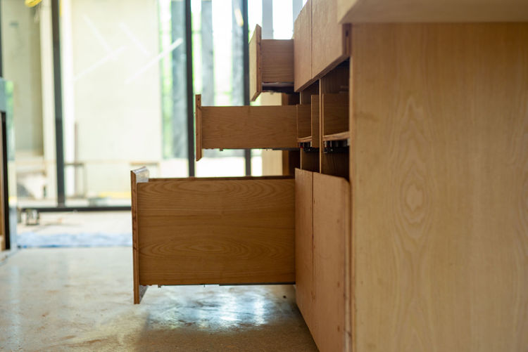 Opening wooden shelves under installation inside the house under construction