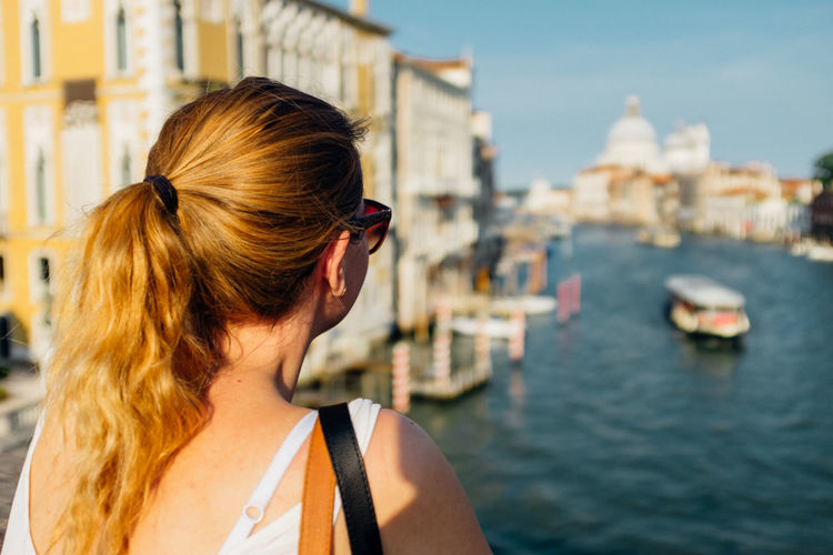 Rear view of woman looking at grand canal in city