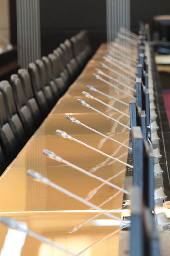 High angle view of empty seats and microphones in room